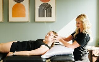 physical therapist assessing neck range of motion for management of neck pain
