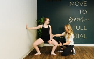 athlete performing sport-specific rehabilitation exercises with a physical therapist