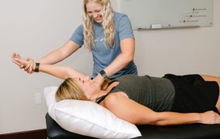 PT assessing shoulder pain