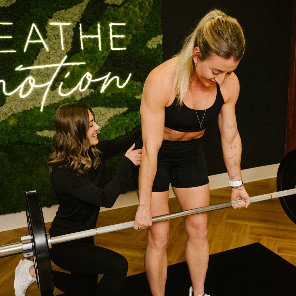 BIM26-1228 physical therapist correcting form on barbell deadlift