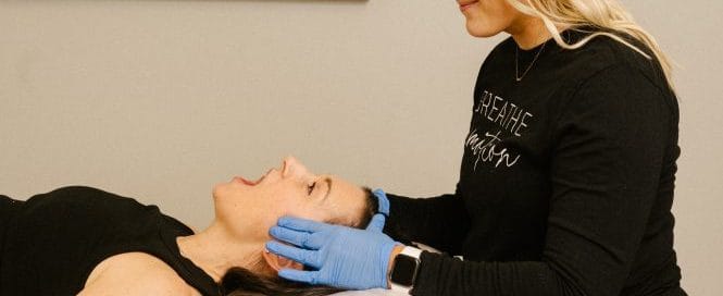 physical therapist assessing for TMJ dysfunction