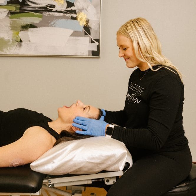 physical therapist assessing for TMJ dysfunction