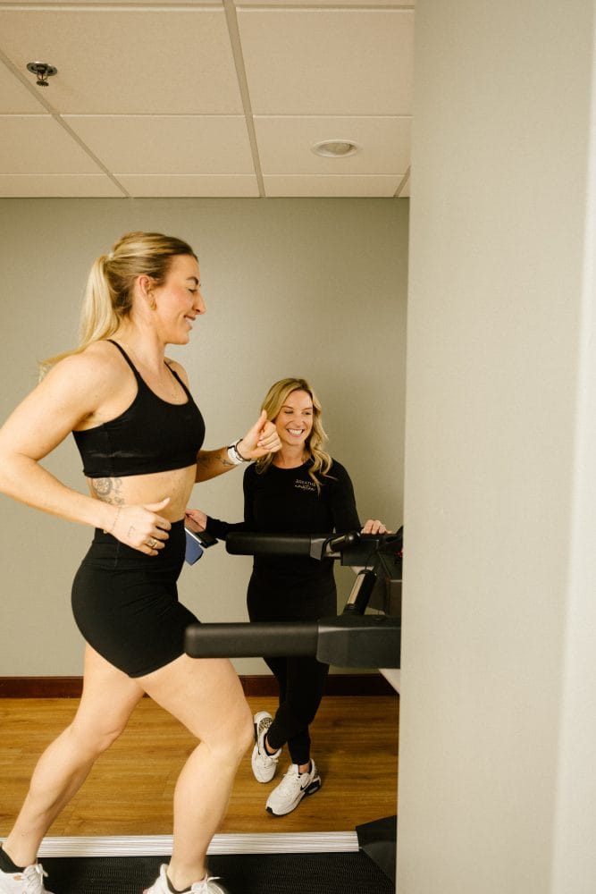 Breathe In Motion physical therapist performing running analysis on a treadmill